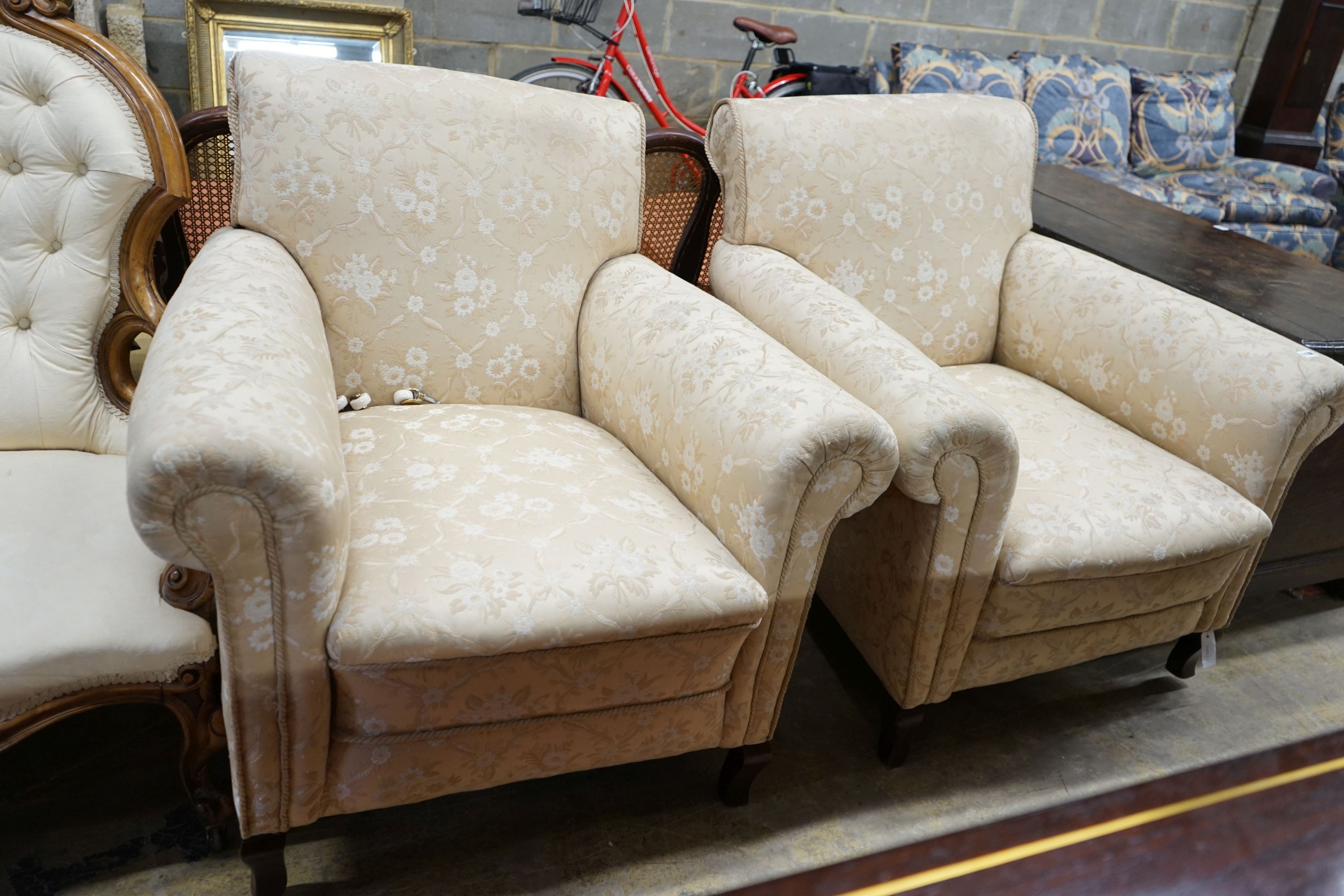 A pair of late Victorian upholstered armchairs, width 90cm, depth 84cm, height 94cm